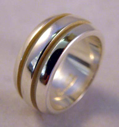 A LADIES TIFFANY AND CO. STERLING SILVER RING with: A LADIES TIFFANY AND CO. STERLING SILVER RING with channel cut design; 6.95 dwt.