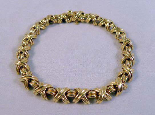 18K LADIES TIFFANY & CO BRACELET: A LADIES 18K TIFFANY & CO. BRACELET with “X” and bar design; 19.95 dwt.