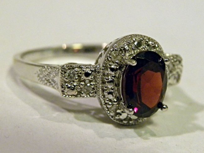diamond & rhodolite garnet ring: 10k wg ring featuring an approx. 1 ct. rhodolite garnet and full cut diamonds around. Size 7. weight is 3.4 g.