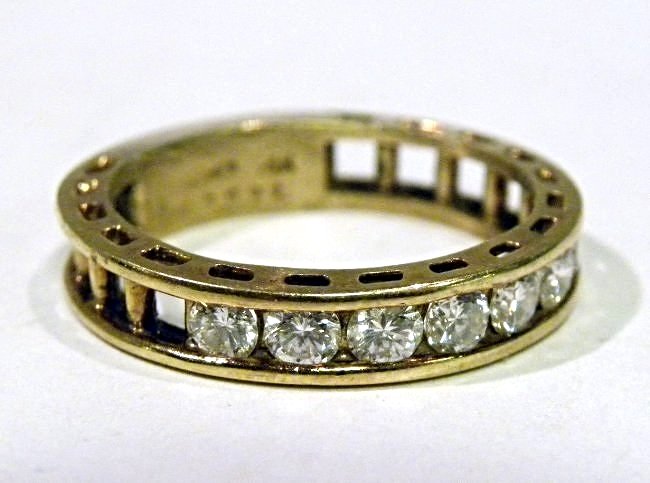 Designer "Add-a-Diamond" Anniverary Ring: "Jose Hess" 14k yg band featuring 7 full cut diamonds weighing approx. .50ct. with 10 spots to add more diamonds. Size 7 1/4. weight is 4.4g