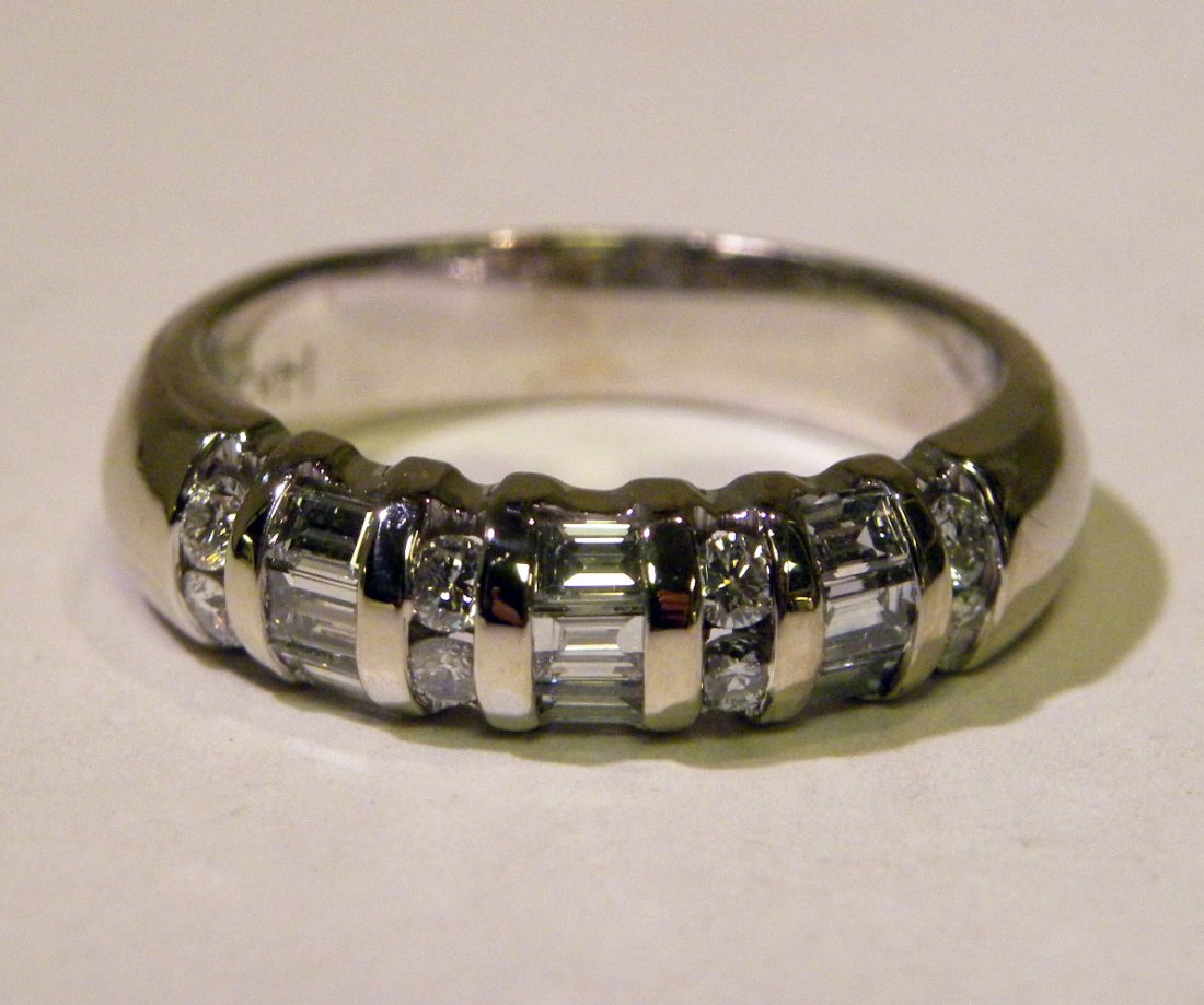 .50ct. Diamond Wedding Band: 14KWG Wedding Band having both Round and Bagguette Chanel Set Diamonds with a total weight of approx. .50ct. VS clarity F-G color Size 7 5.3 Grams