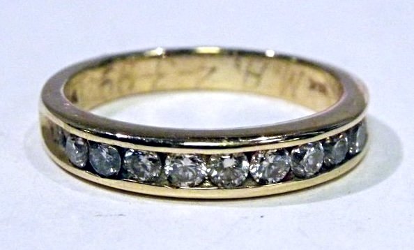 .30ct Diamond Wedding Band: 14k yg wedding band having approx. .30ct twt of round brilliant cut diamonds of VS clarity and TTLB color, channel set. Size 5 3/4. weight 3.5g.