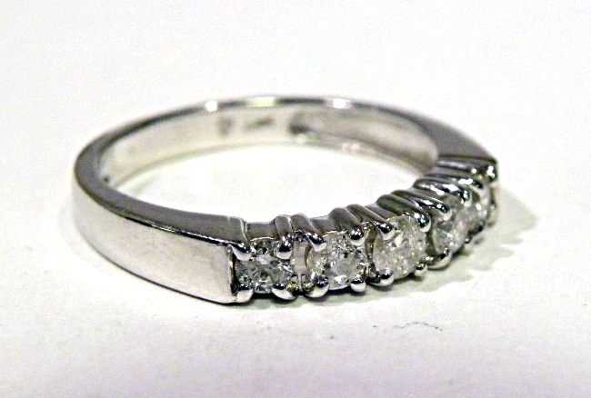 .50ct Diamond Wedding Band: 14k wg band featuring 5 full cut round diamonds, total weight approx. .50ct I1-2 clarity H color. Size 7. weight 3.3g.