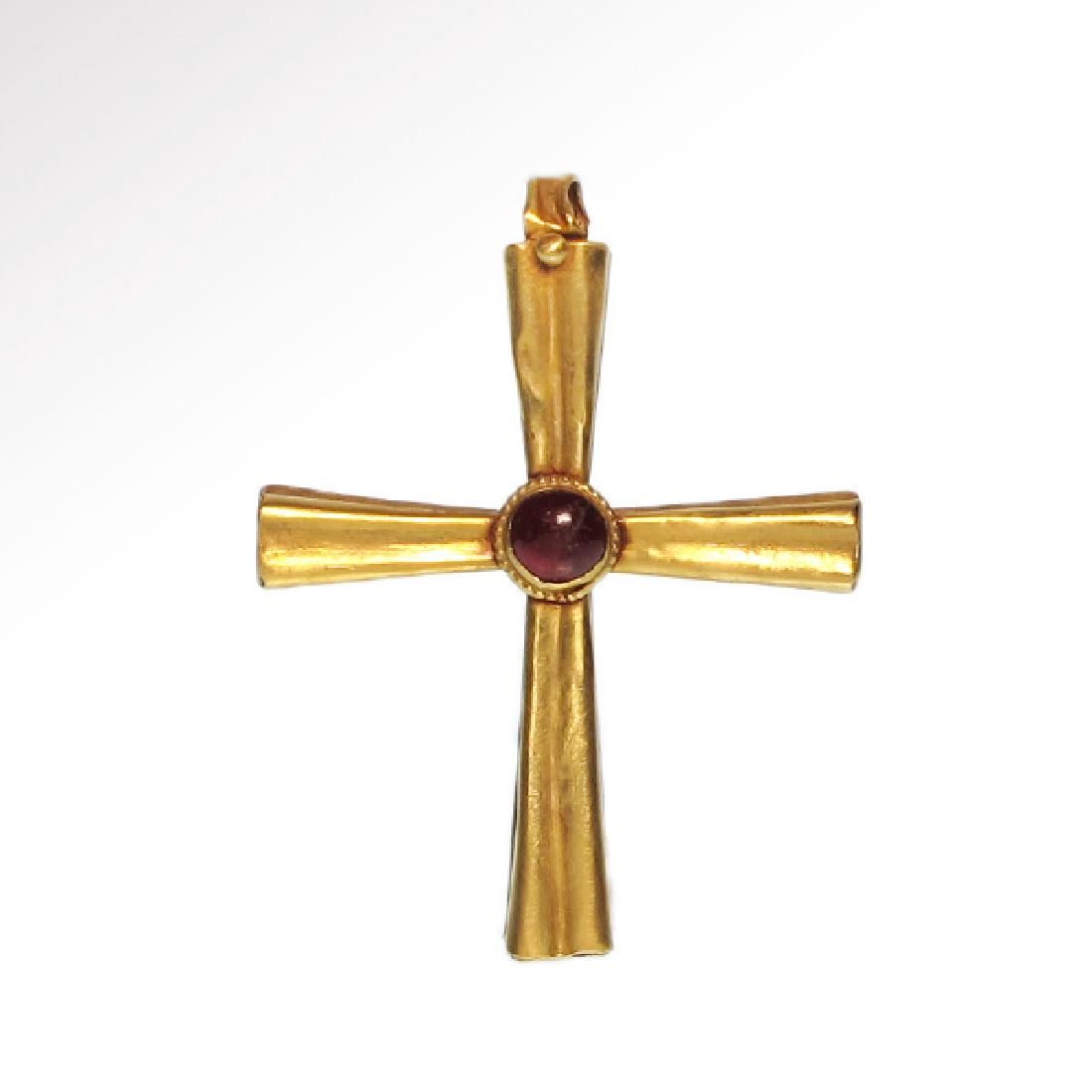 Byzantine Gold and Garnet Cross, 10th-12th Century A.D.: Byzantine Gold and Garnet Cross, c. 10th-12th Century A.D. Hollow gold cross with flared arms, the centre inset with a round garnet surrounded by gold granules. Size:5.9 cm L - 2 3/8 inches Material:G