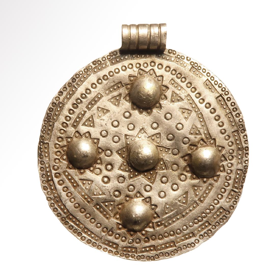Viking Silver Pendant, c. 10th Century A.D.: Viking Silver Pendant, c. 10th Century A.D. Decorated with punch pattern with five repousse knobs surrounded by stars, round and triangles patterns. Size:5.1 cm D - 2 inches (including loop) Material: