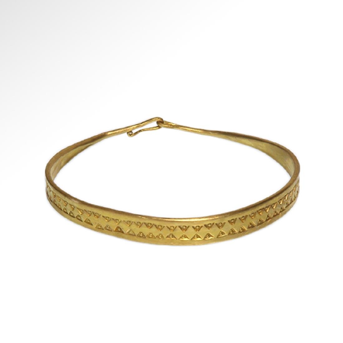 Viking Decorated Gold Bracelet, c. 10th Century A.D.: Viking Decorated Gold Bracelet, c. 10th Century A.D. Flat gold bracelet, tapering at the terminals to form a clasp, decorated with two rows of triangular punch marks. Size:5.9 cm inside D - 2 3/8 inch