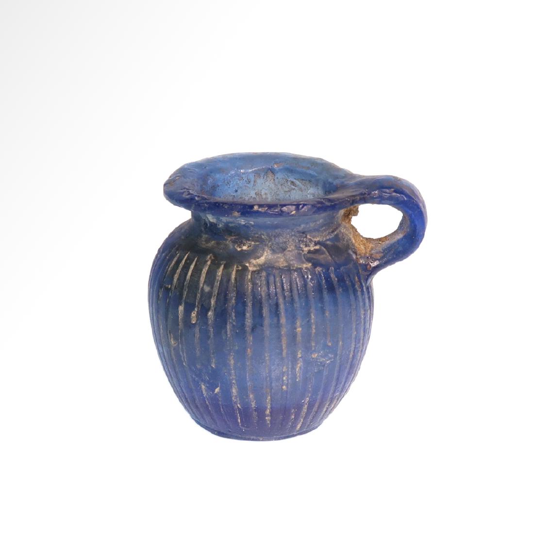 Rare Italian Roman Glass Oinochoe, Italy, c. 1st-2nd: Rare Italian Roman Glass Oinochoe, Italy, c. 1st-2nd Century A.D. The barrel shape body with fine ribs, narrowing to a short neck and flaring lip, wide strap handle. Size:4.3 cm H - 1 11/16 inches Mat