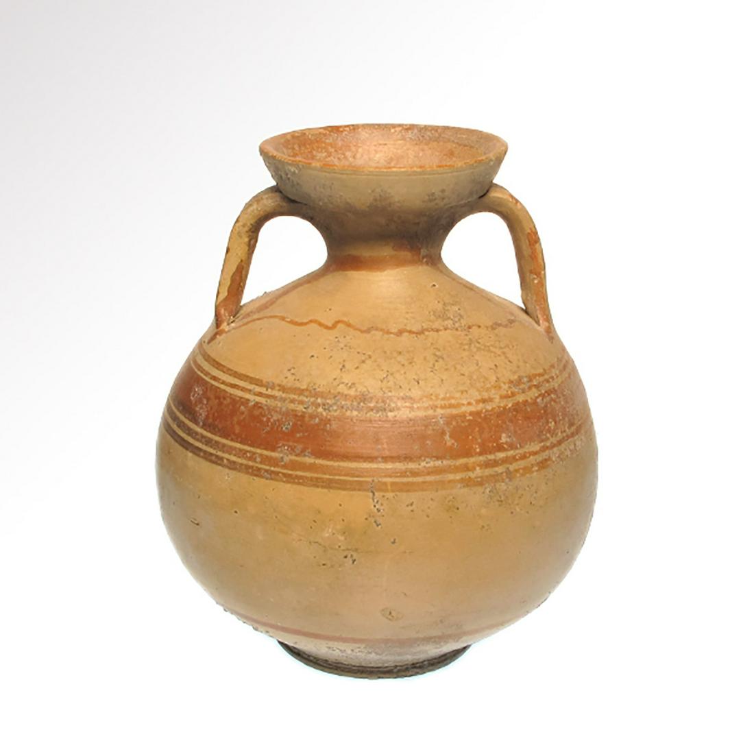 Daunian Terracotta Amphora, South Italy, 5th-4th: Daunian Terracotta Amphora, South Italy, 5th-4th Century B.C. Bulbous body on ring foot, flaring mouth, two strap handles, painted with encircling lines in red slip. Size:12.2 cm H - 4 13/16 inches Ma