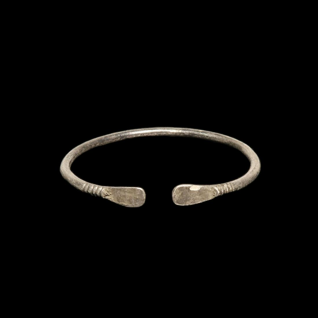 Viking Silver Bracelet with Trapezoidal Terminals: Viking Silver Bracelet with Trapezoidal Terminals Solid silver hoop of round section, widening at the terminals in trapezoidal plate finials. Size:6 cm inside D - 2 3/8 inches Material:Silver, 15.2 gr