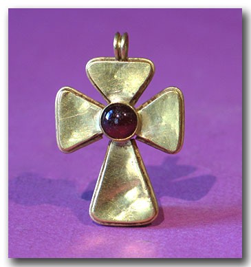 Byzantine Gold and Garnet Cross: Byzantine Gold and Garnet Cross, c. 9th Century A.D. Hollow gold cross with flared arms, the centre inset with an oval garnet. Loop at the top for suspension. Size: 4 cm L - 1 5/8"