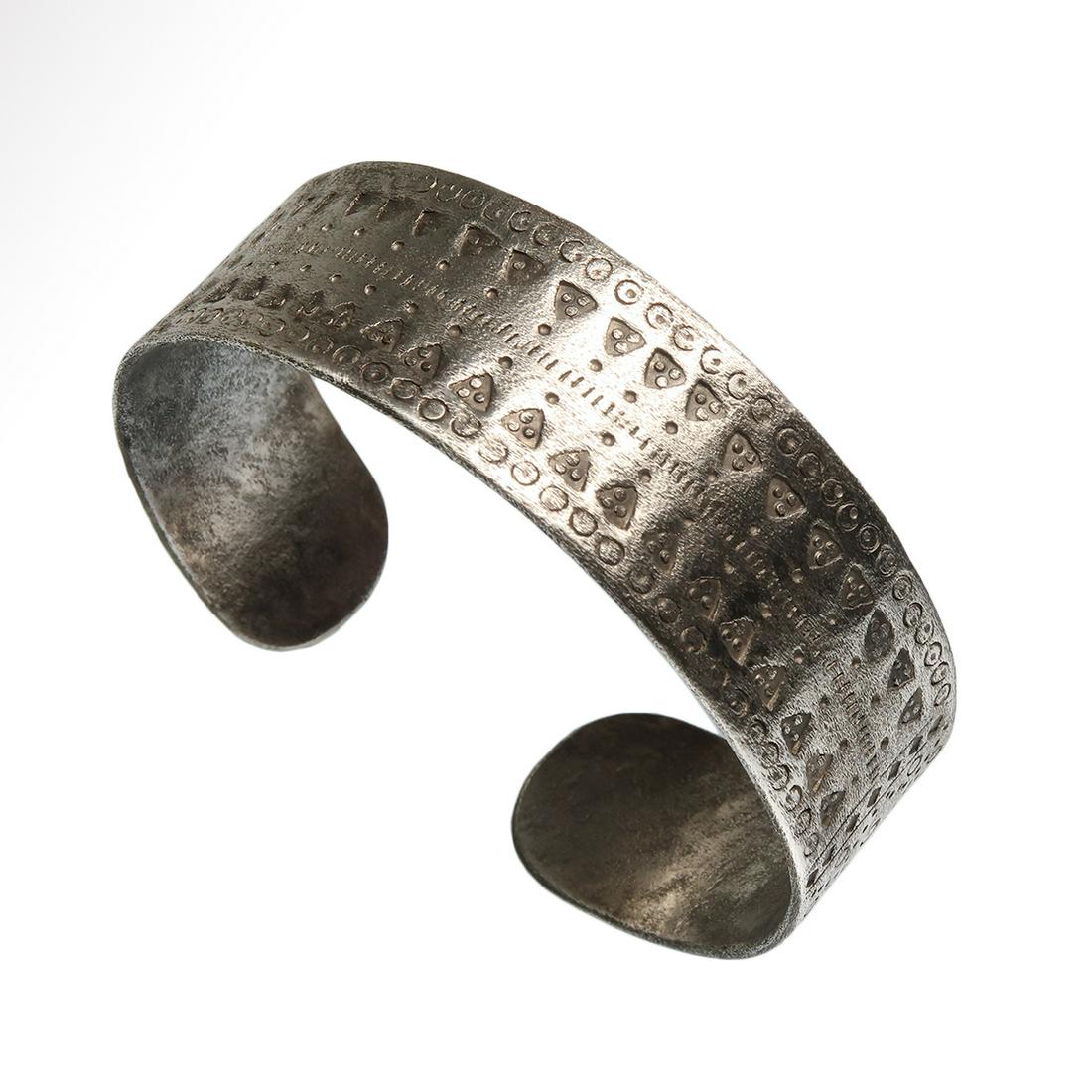 Viking Silver Bracelet, c. 9th-11th Century A.D.: Viking Silver Bracelet, c. 9th-11th Century A.D. Flat-section silver penannular bracelet hammered from a thick silver sheet, the surface ornamented with punched triangles with three dots in the middle