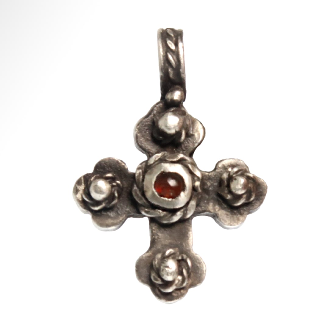 Byzantine Silver Cross with Garnet and Filigree, c. 10th Century A.D.: Byzantine Silver Cross with Garnet and Filigree, c. 10th Century A.D. Hollow silver cross with flared arms, each decorated with a granule and rope pattern of a rosette. The centre inset with a cabocho