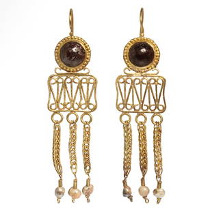 Roman Filigree Gold and Garnet Earrings, c. 2nd - 3rd Century A.D.: Roman Filigree Gold and Garnet Earrings, c. 2nd - 3rd Century A.D.Each with a round cabochon garnet, open-work wire scrolls pattern and three pendants with loop in loop chains, each with a suspended p