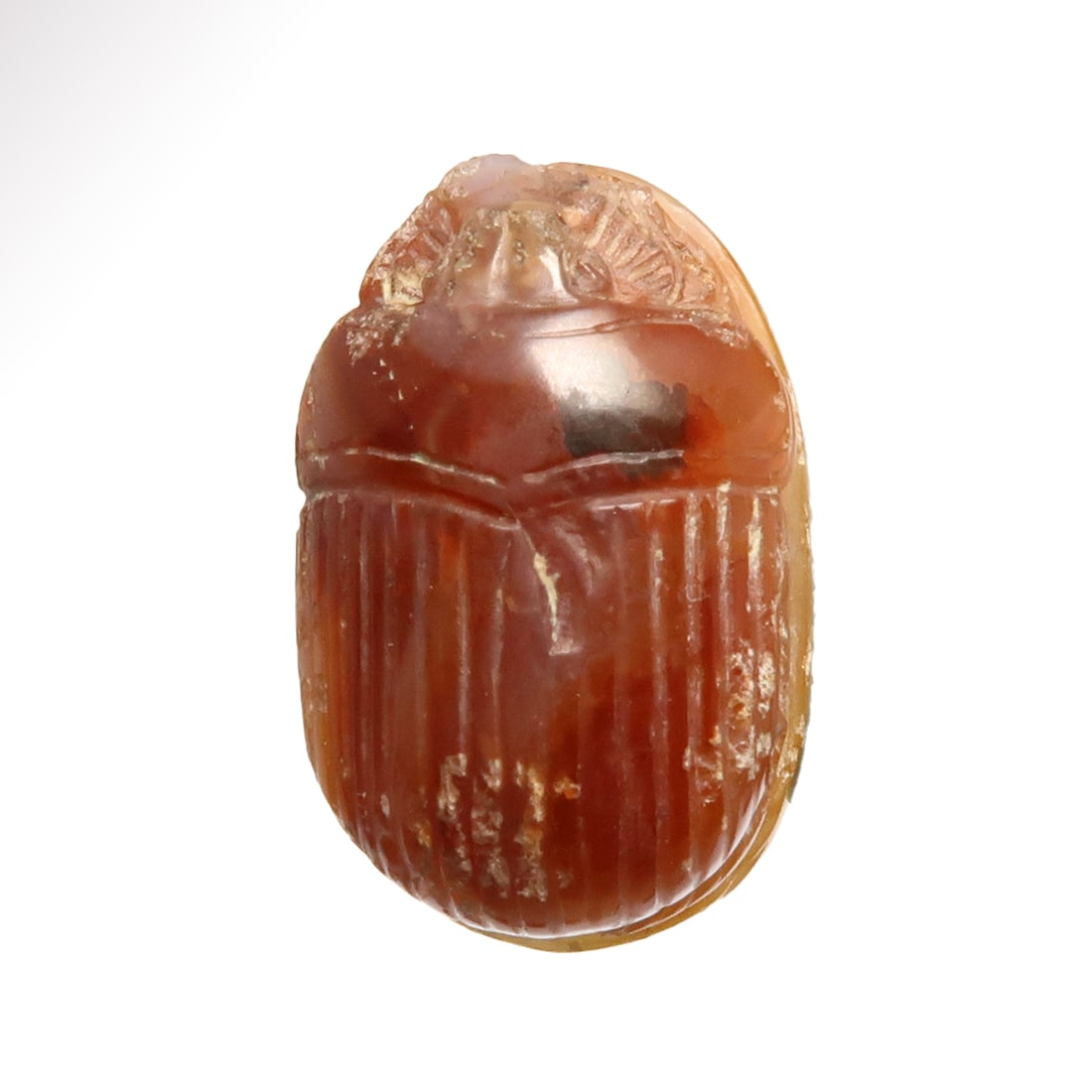 Egyptian Agate Scarab, New Kingdom, c. 1700 B.C.: Egyptian Agate Scarab, New Kingdom, c. 1700 B.C.Nicely carved with realistic features, the base carved with the figure of a scarab and sun disk, symbol of the rising sun as the god Khepri, surrounded