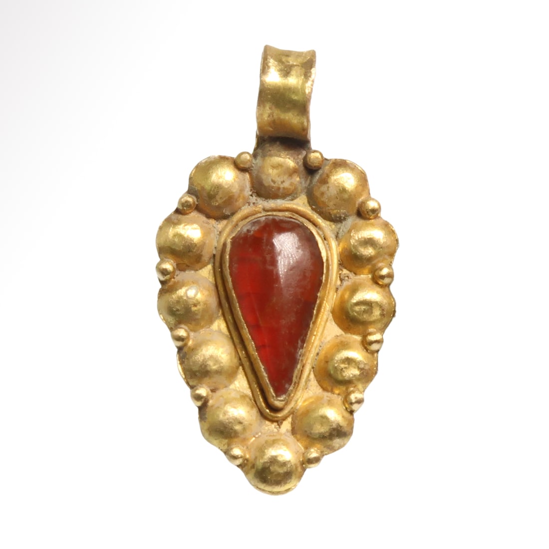 Roman Gold and Garnet Pendant, c. 2nd-3rd Century A.D.: Roman Gold and Garnet Pendant, c. 2nd-3rd Century A.D. Teardrop solid gold pendant, finely worked with granules, large and small, the centre set with a teardrop cabochon garnet. Loop on top for suspen