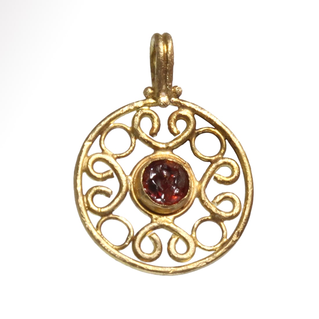 Roman Gold and Garnet Open Work Filigree Pendant, c. 2nd Century A.D.: Roman Gold and Garnet Open Work Filigree Pendant, c. 2nd Century A.D. Round pendant with central cabochon garnet, decorated in open-work with tendrils pattern. Loop at the top for suspension. Size:2.4