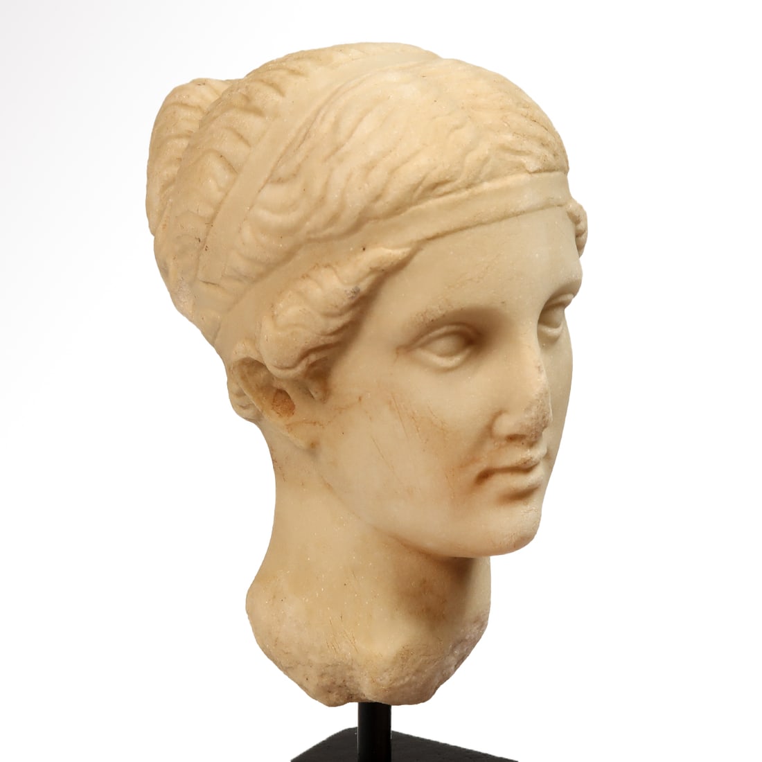 Roman Marble Head of Venus, c. 2nd Century A.D.: Roman Marble Head of Venus, c. 2nd Century A.D.Softly modelled features, bow lips closed, almond shaped eyes gazing forward, wavy hair drawn into a pronounced chignon at the back held up with a double