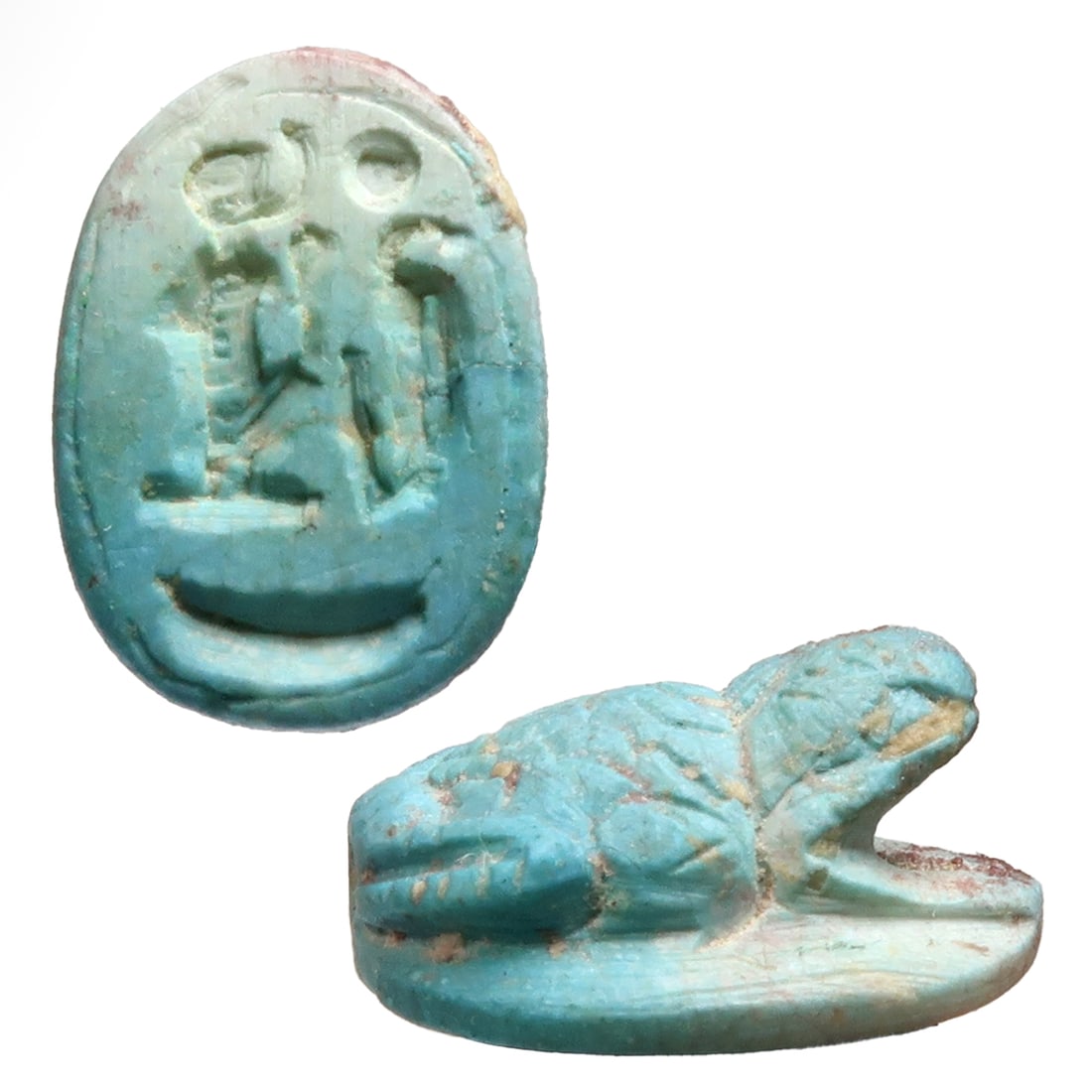 Egyptian Faience Frog Scaraboid with Hieroglyphs, Ptolemaic Period, c. 300 B.C.: Egyptian Faience Frog Scaraboid with Hieroglyphs, Ptolemaic Period, c. 300 B.C.With crouching frog to the upper face, the base deeply engraved with hieroglyphs. Exquisite.Size:2 cm L - 3/4 inch Materi