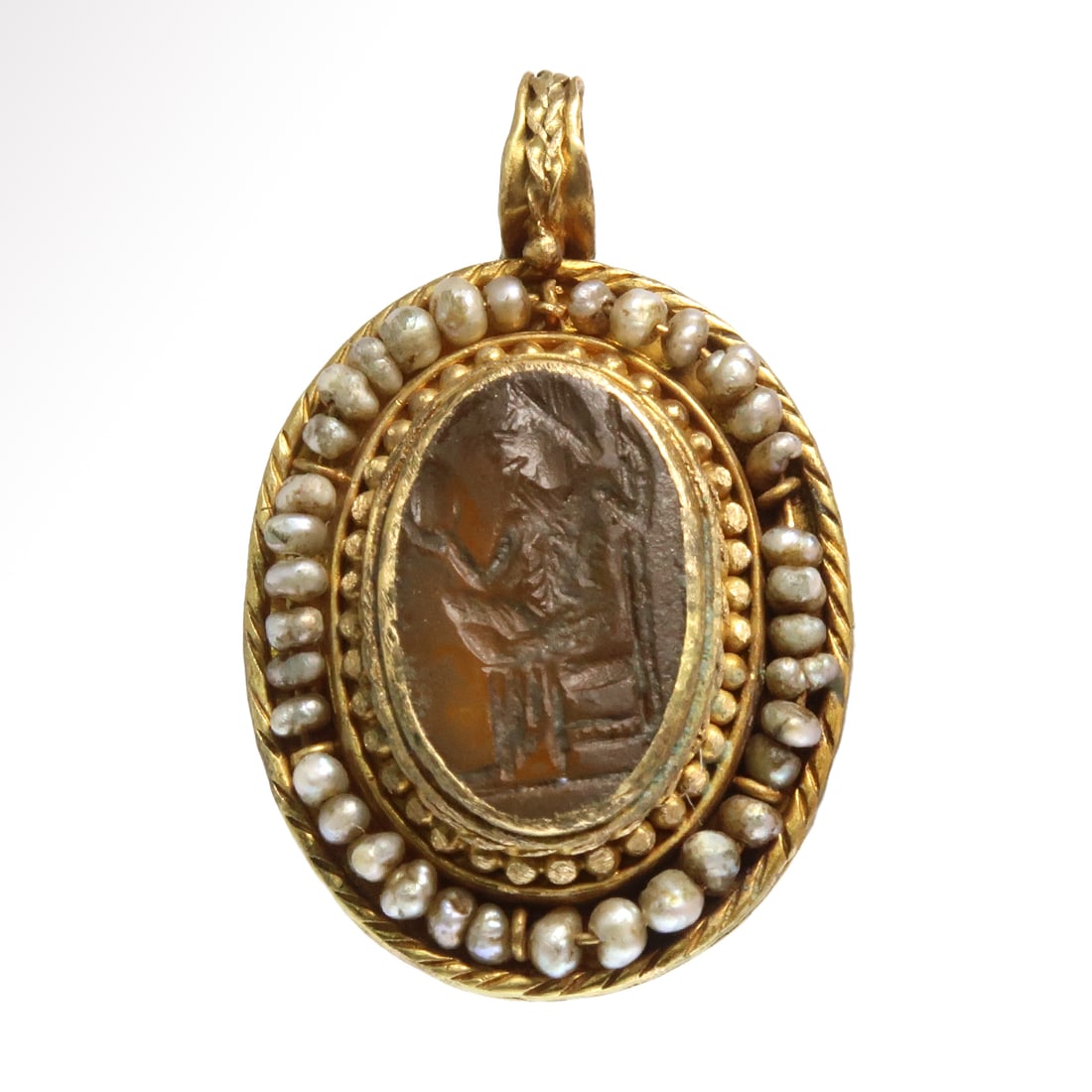 Roman Gold and Mother of Pearl Pendant with Cornelian Intaglio, c. 2nd Century A.D.: Roman Gold and Mother of Pearl Pendant with Cornelian Intaglio, c. 2nd Century A.D.The centre set with an oval cornelian intaglio engraved with the figure of man seated on a throne, holding a mirror i