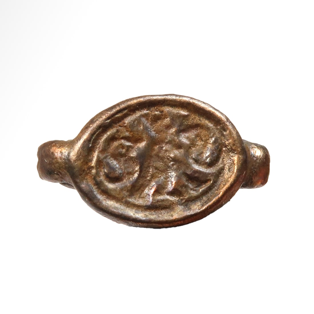 Phoenician Bronze Scaraboid Pendant, c. 6th-4th Century B.C.: Phoenician Bronze Scaraboid Pendant, c. 6th-4th Century B.C.A central design featuring a falcon deity (Ra or Ra-Horakhty) flanked by two uraei, the back with suspension loop terminating in scrolls. Ex