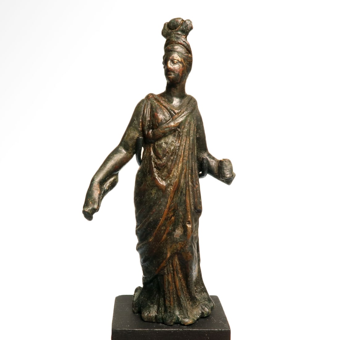 Roman Bronze Figure of Isis-Aphrodite, c. 2nd Century A.D.: Roman Bronze Figure of Isis-Aphrodite, c. 2nd Century A.D.The goddess standing, her head turned to the right and surmounted by the crown of Isis consisting of cow horns and the solar disk. Wearing a d