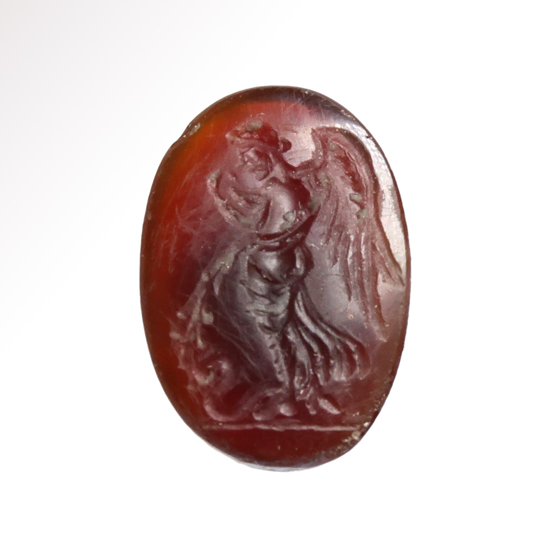 Roman Cornelian Intaglio with Eros/Cupid, c. 1st Century A.D.: Roman Cornelian Intaglio with Eros/Cupid, c. 1st Century A.D.Oval cornelian intaglio beautifully engraved with Eros/Cupid, large wings, draped, standing in front of a snake, holding an olive branch in