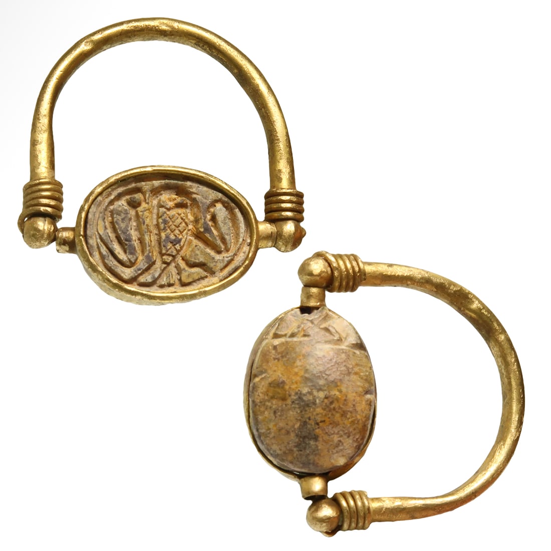 Egyptian Steatite Scarab in Gold Swivel Ring, engraved with Hieroglyphs, c. 1000 B.C.: Egyptian Steatite Scarab in Gold Swivel Ring, engraved with Hieroglyphs, c. 1000 B.C.Steatite scarab, the base engraved with a central owl flanked by two ureai cobras, framed with gold, set in a gold