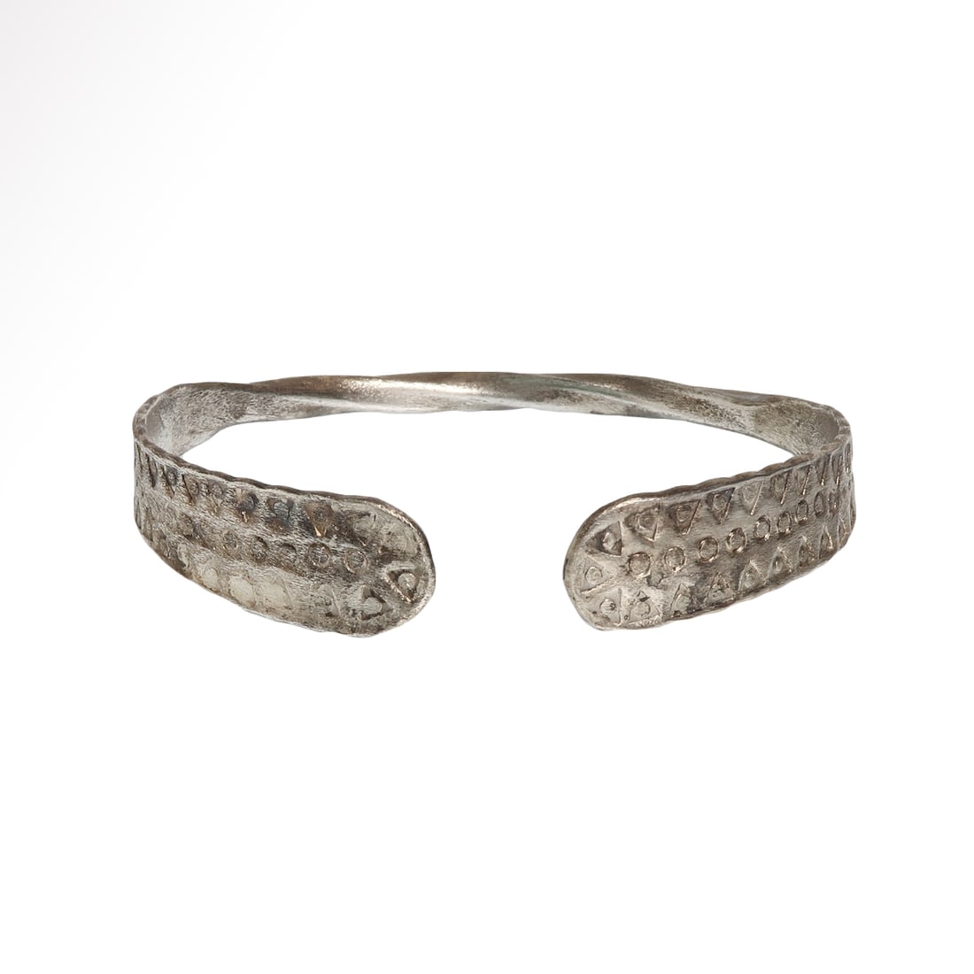 Viking Silver Bracelet, Norse Style, c. 9th Century A.D.: Viking Silver Bracelet, Norse Style, c. 9th Century A.D.Square sectioned and twisted silver, flattened at the terminals. Tightly punched surface with triangles with pellets, the sides with wavy edges.