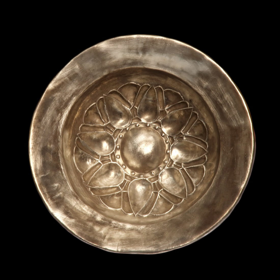 Greek Hellenistic Silver Bowl with Lotus Motif, c. 3rd Century B.C: Greek Hellenistic Silver Bowl with Lotus Motif, c. 3rd Century B.CSilver bowl with flared edge and rolled rim, repousse lotus-leaf detailing to the bowl with central dome and pellets.Size:12.7 cm D -
