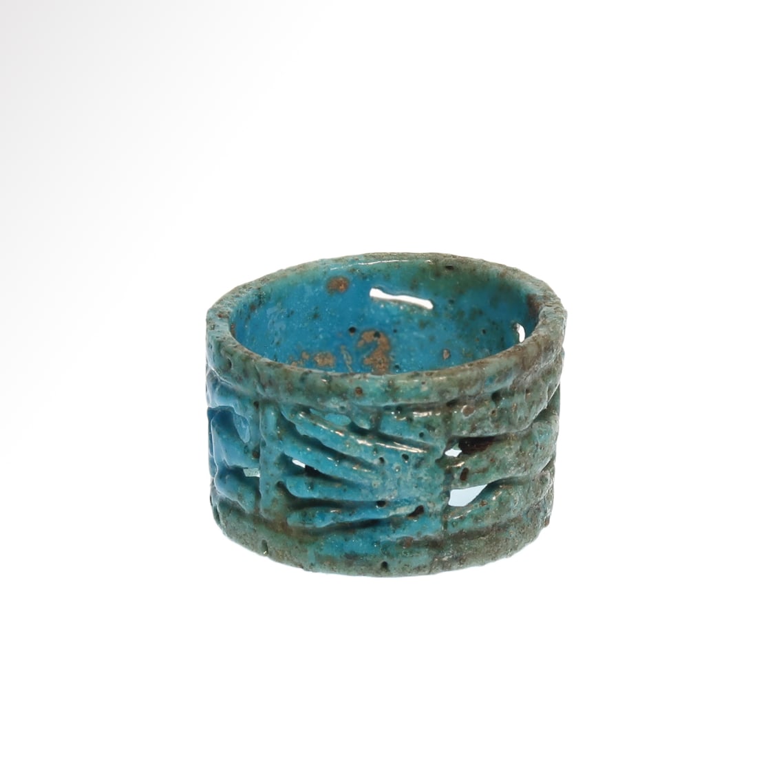 Egyptian Open-Work Faience Ring, 18th Dynasty, c. 1500 B.C.: Egyptian Open-Work Faience Ring, 18th Dynasty, c. 1500 B.C.The open work showing standing Anubis in his human body form and jackal head with pointed ears and two lotus flowers Tete-Beche.Size:2.6 cm D