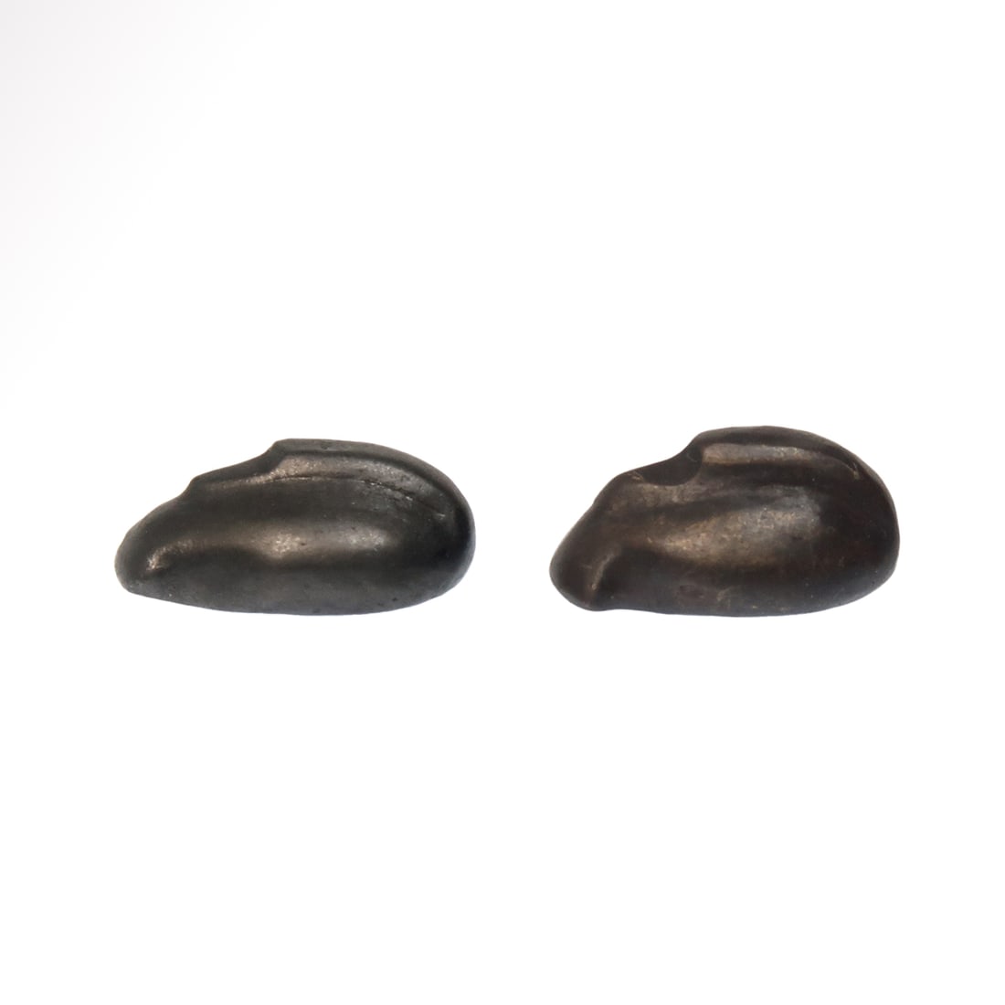 Two Babylonian Hematite Duck Weights, c. 1800 -1700 B.C.: Two Babylonian Hematite Duck Weights, c. 1800 -1700 B.C.Probably for weighing gold or silver. Both very nicely carved and polished ducks with heads resting on their backs.Size:1.5 cm L each - 9/16 inc
