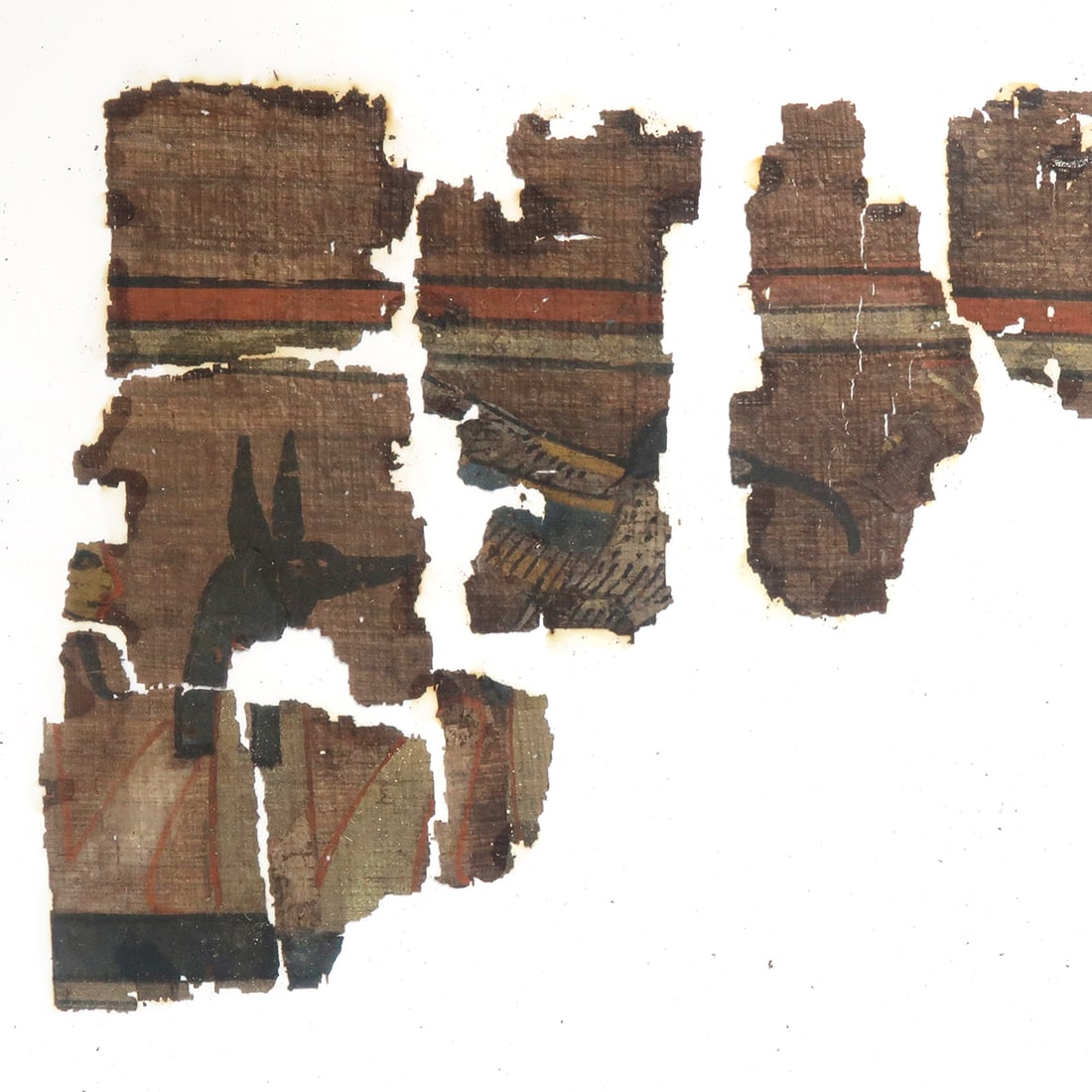 Egyptian Fragments of Papyrus with Anubis and Ibis, 18th-19th Dynasty, c. 14th-13th Century B.C.: Egyptian Fragments of Papyrus with Anubis and Ibis, 18th-19th Dynasty, c. 14th-13th Century B.C.Eleven fragments of ink inscribed papyri with remains of polychrome vignette, from Chapter 148 containin