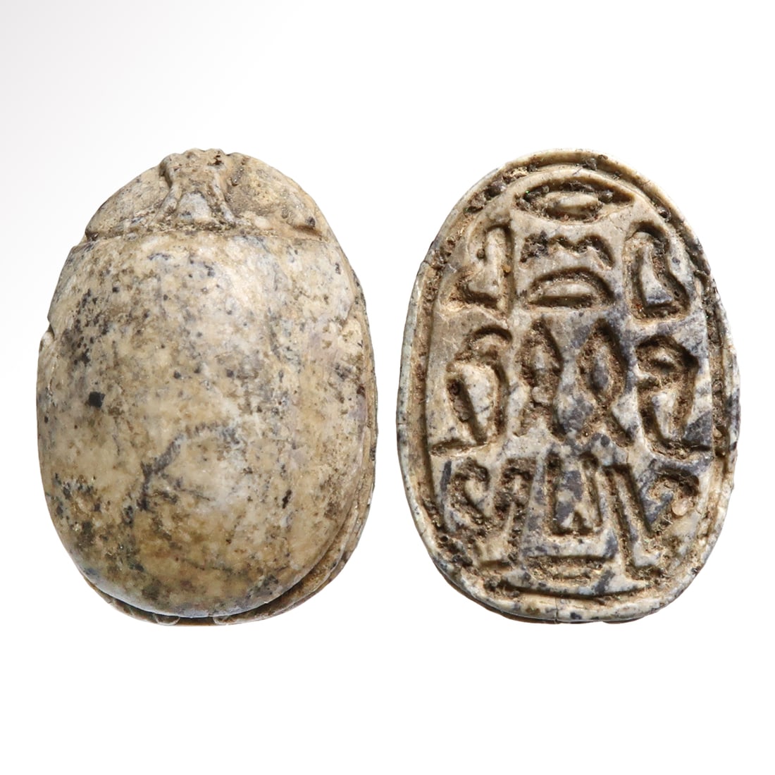Egyptian Granite Scarab with Protective Spell, c. 900 B.C.: Egyptian Granite Scarab with Protective Spell, c. 900 B.C.Finely carved with realistic features, the base deeply engraved with a protective spell composed by, on either side, a maat feather (rightness
