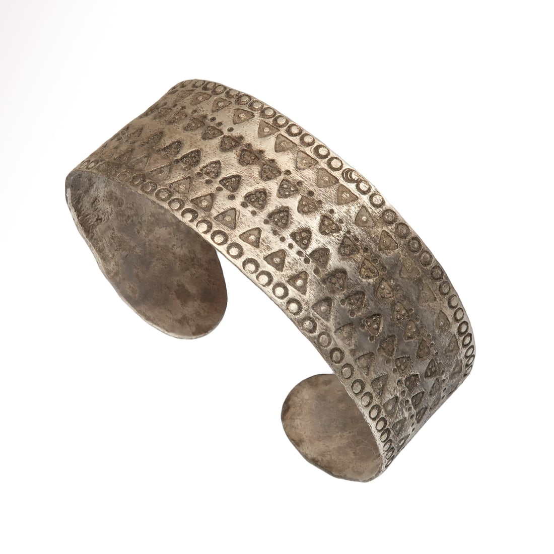 Viking Silver Bracelet with Wolf?s Tooth Decoration, c. 9th-11th Century A.D.: Viking Silver Bracelet with Wolf?s Tooth Decoration, c. 9th-11th Century A.D. Flat-section silver penannular bracelet hammered from a thick silver sheet, the surface ornamented with two central lines 