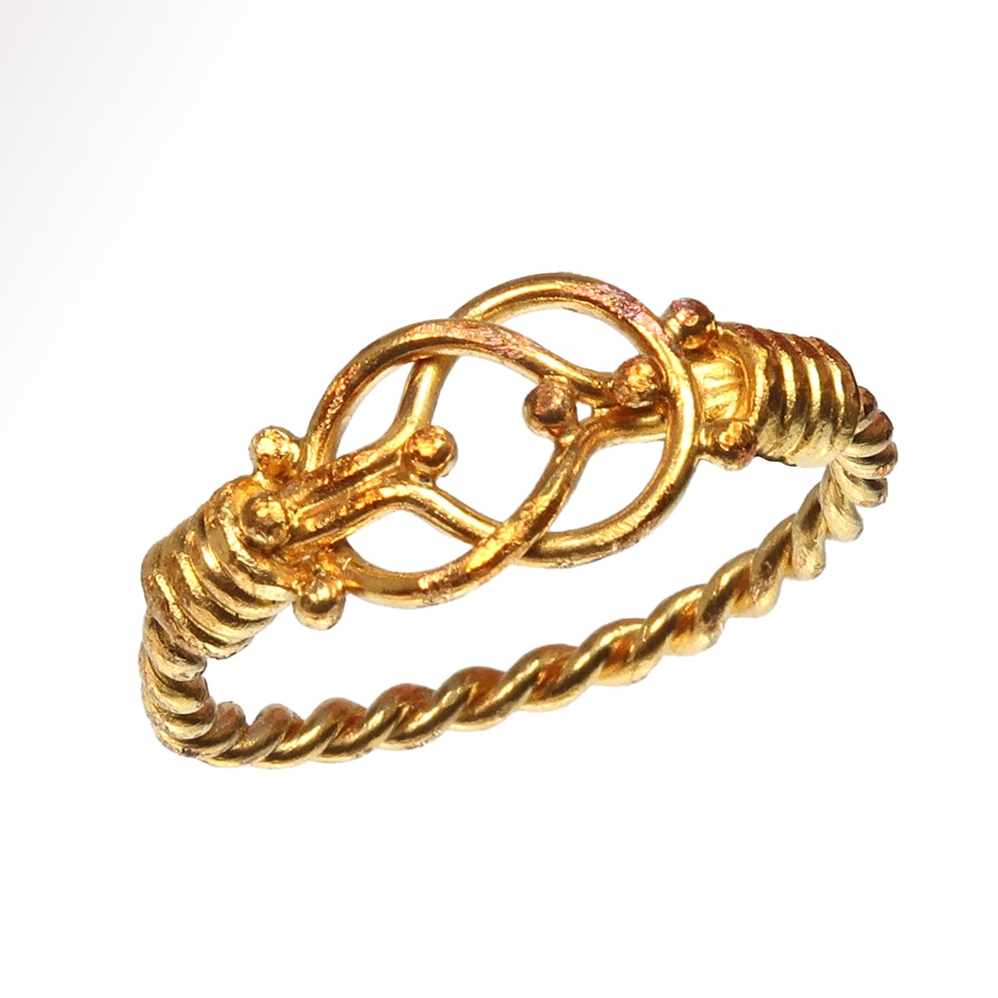 Medieval Gold Ring with Hercules Knot, c. 12th-13th Century A.D.: Medieval Gold Ring with Hercules Knot, c. 12th-13th Century A.D. Of solid gold, the shank made of a single twisted wire leading to a bezel fashioned into Hercules knot pattern, twisted around the oppo
