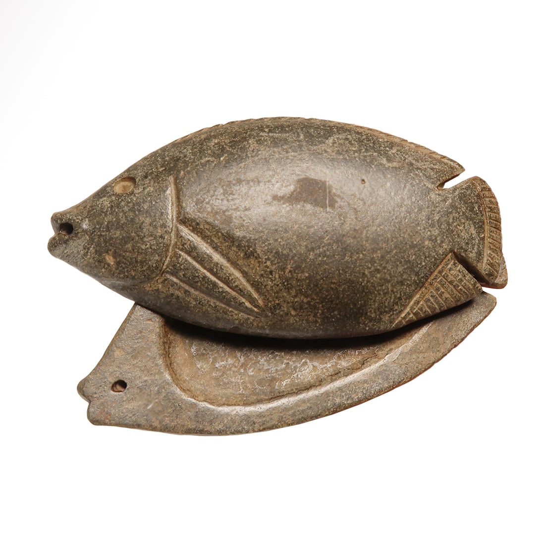 Egyptian Steatite Fish Shaped Cosmetic box, c. 1500 B.C.: Egyptian Steatite Fish Shaped Cosmetic box, c. 1500 B.C. Carved serpentine two-part cosmetic box representing a bolti fish, internally recessed, pierced through mouth for suspension and partially thro
