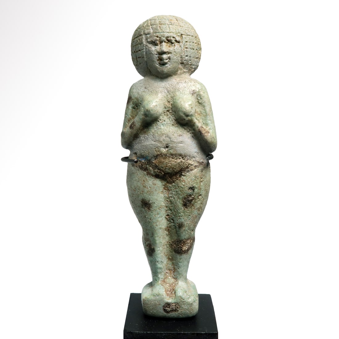 Egyptian Blue-Glazed Bichrome Faience Female Concubine Figure, c. 600 B.C.: Egyptian Blue-Glazed Bichrome Faience Female Concubine Figure, c. 600 B.C. Wearing a short wig, deeply incised details of the hair and face, hands to the breast and a broad girdle in black. Under glaz