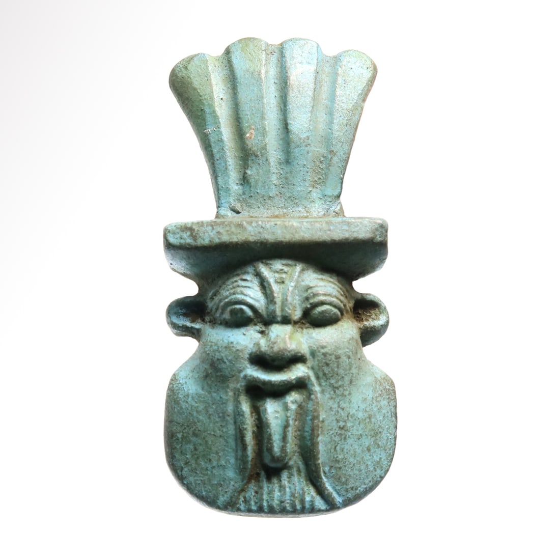 Egyptian Turquoise Faience Head of Bes Amulet, c. 600 B.C.: Egyptian Turquoise Faience Head of Bes Amulet, c. 600 B.C. Finely detailed, feather headdress and full beard with curving moustache, broad snub nose and leonine ears. Pierced for suspension. Size:5.4 