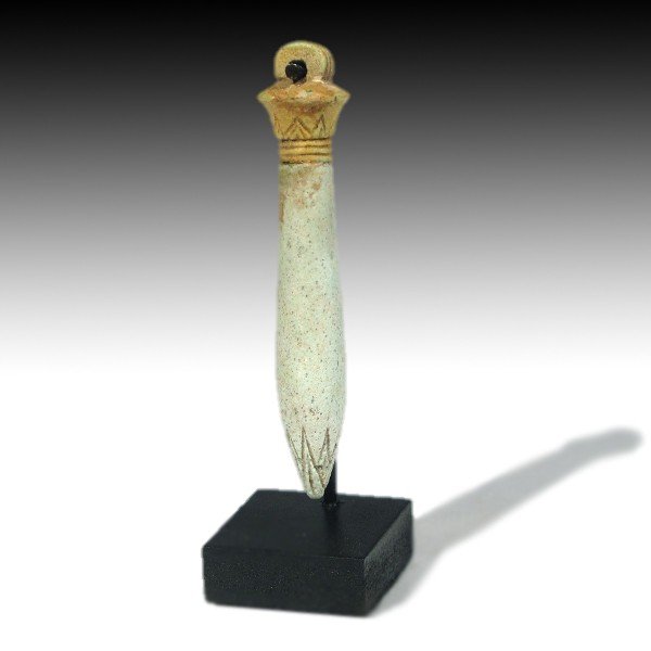 Egyptian Faience Papyrus Sceptre, c. 350 B.C.: Egyptian light turquoise faience amulet of a papyrus sceptre with lotus flower design and ribbed loop for suspension. Material:Faience Size:6.7 cm L - 2 5/8 inches Provenance: Belgian collection, acqu