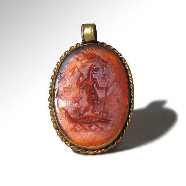 Large Gnostic Cornelian Intaglio set in Gold: Large Gnostic Cornelian Intaglio set in Gold, with Figures and Magical Inscriptions, 2nd-4th Century A.D. Large oval cornelian Gnostic intaglio engraved with the figure of the Egyptian deity Anubis st