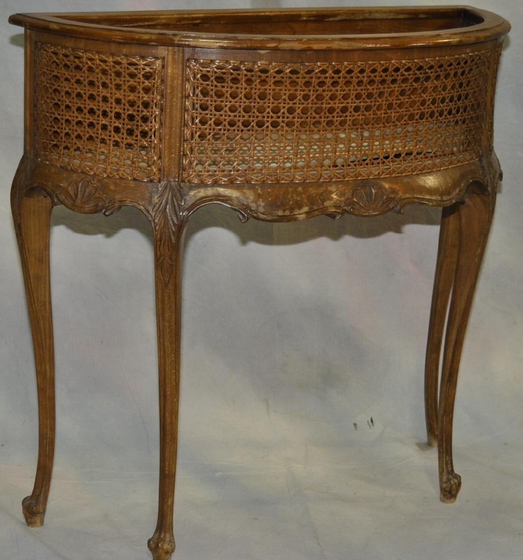 Rococo Style Walnut Demilune Fernier: Caned front panels, water worn finish but sound and solid, no breaks in the caning, 26 in, x 27.25 in. x 11 in.
