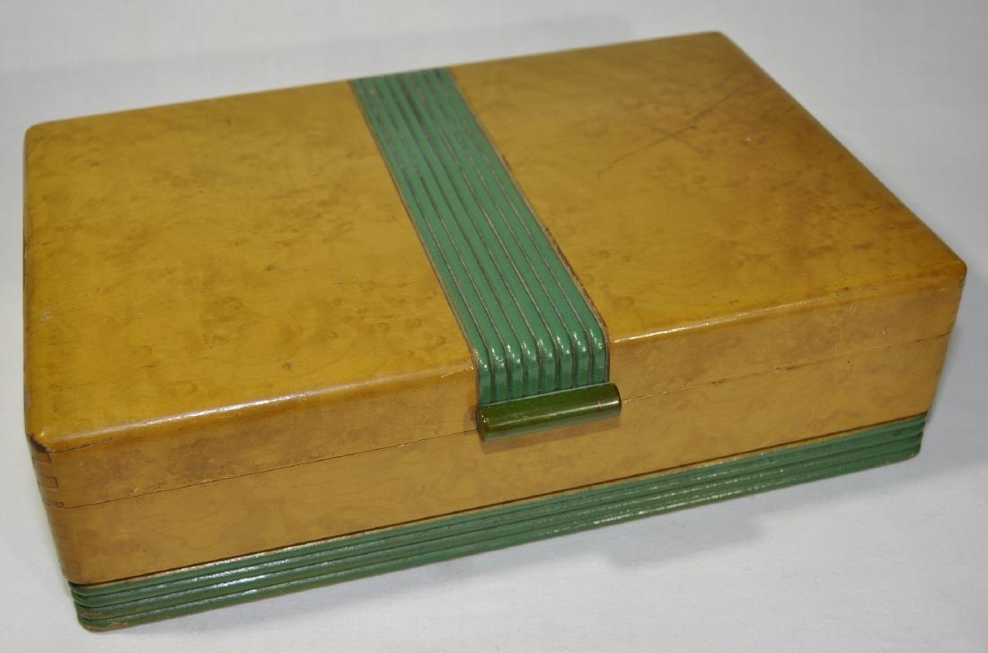 Pilliod Cabinet Co. Art Deco Box: Swanton, Ohio. Dovetailed burlwood, original textured paper lined interior and mirrored lid, bakelite handle, 3 in. x 10.25 in. x 6.75 in.