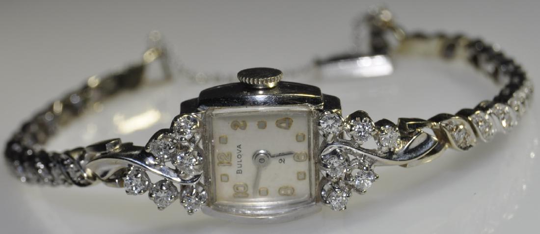 14K White Gold Bulova Ladies Wristwatch C. 1960: 23 Jewels, 6 in. linked bracelet mounted with twenty-eight approximately 2mm bead set round white diamonds, linked to raised lugs mounted with twelve approximately 2.5mm round white diamonds totaling 