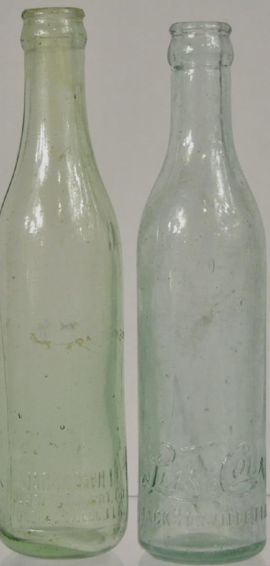 2) Early Jacksonville, Fl. Pepsi Cola Bottles: 1) Script logo at the base, 9 in., case wear, chips on heel, 1) block letter logo at the base, rounded heel, 9 in., case wear, no chips.
