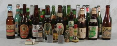 Beer Bottles: Collection includes 27 vintage beer bottles, most of European or Canadian beers. Together with miniature liquor bottles and three Zippo lighters.
