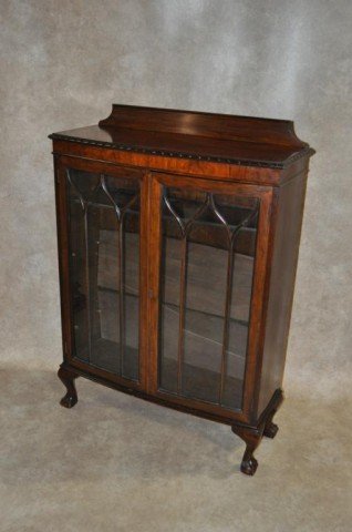 Gothic Style Mahogany Bookcase: Adjustable walnut shelves, ten individual panes forming doors, swell front, ball and claw feet, gadrooned top, H 50" W 37" D 14"