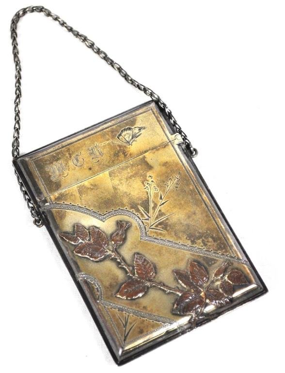 Aesthetic Period Mixed Metals Calling Card Case: Primarily sterling with gold wash and copper or bronze overlays, monogrammed M.E.H., retains original link handle and (3) calling cards of Mrs. Mary E. Hazelhurst; Measurements: 3 3/4" x 2 1/8"