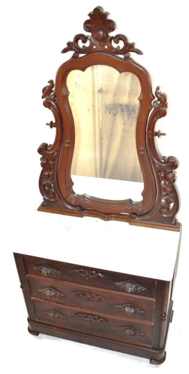 Antique Walnut Dressing Table: Transitional piece bridging American Classical and later Victorian elements, featuring an elaborately shaped and pierce-carved cheval mirror on stand above a white marble top which in turn surmounts a
