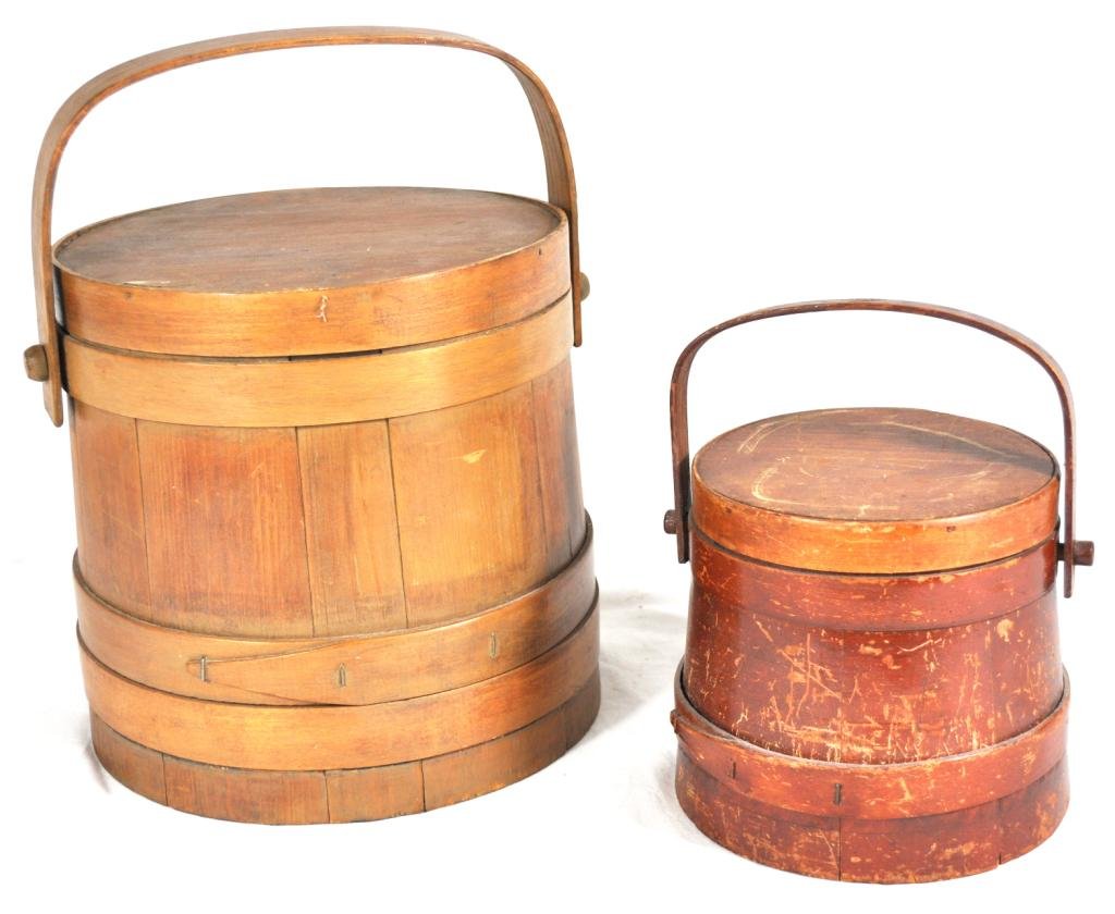 Furkins, 2 Pcs.: Stave constructed, w/swing handles, (1) tapering toward the lid, H 6 1/2"; (1) straight sided, H 10".; Measurements: See Description