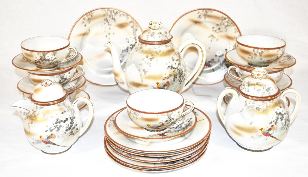 Satsuma Dessert Set, 17 pcs: All hand enameled with pheasants under blooming tree motif, (1) tea pot, H 7 1/2"; (1) covered sugar, H 6"; (1) covered cream pitcher, H 5 1/2"; (7) plates, D 7"; (7) cups and saucers. (1) cup is crac